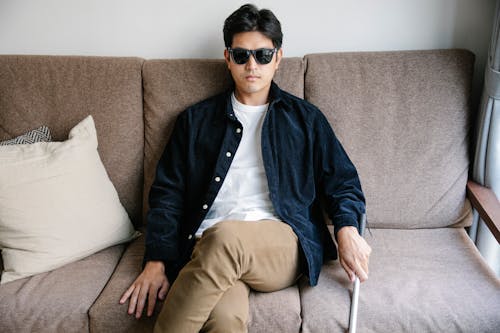 Photo Of Man Sitting On A Couch