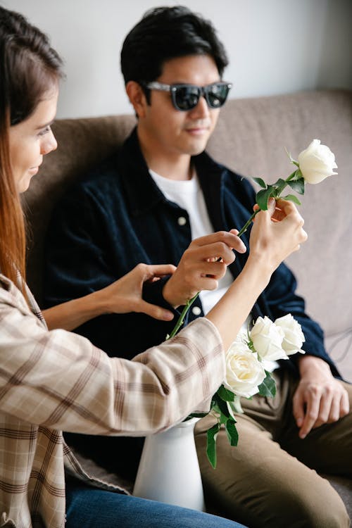 Photo Of Couple Holding A White Flower