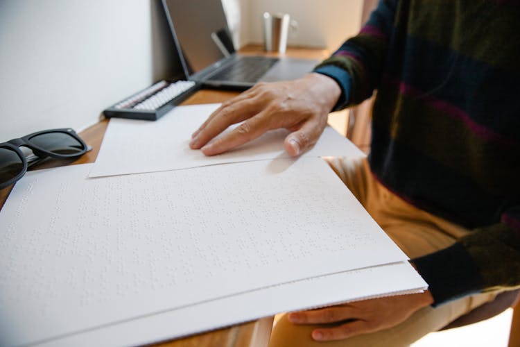 Person Touching White Dotted Paper