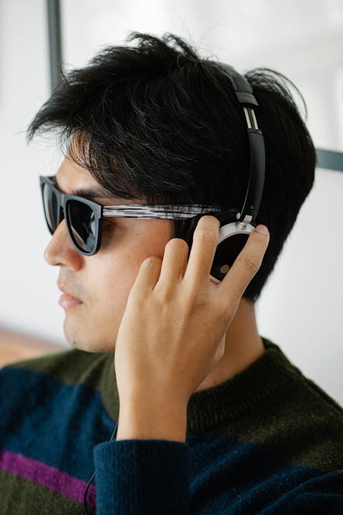 Free Close-Up Photo of Man Using Headphones Stock Photo