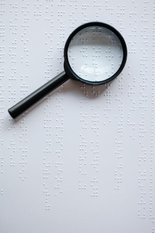 Free Photo of Magnifying Glass on Top of Braille Stock Photo