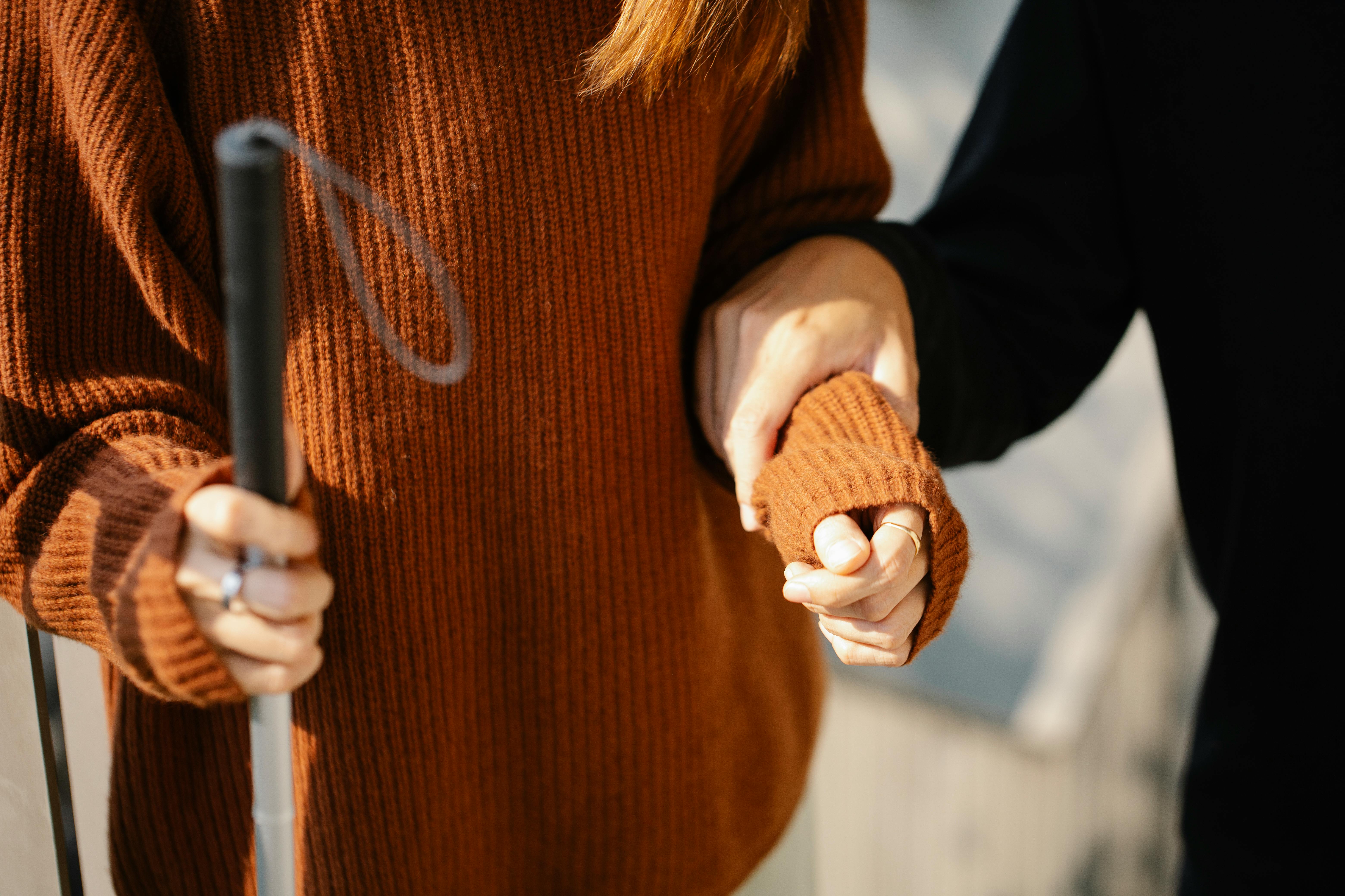 photo of man holding on woman s arm