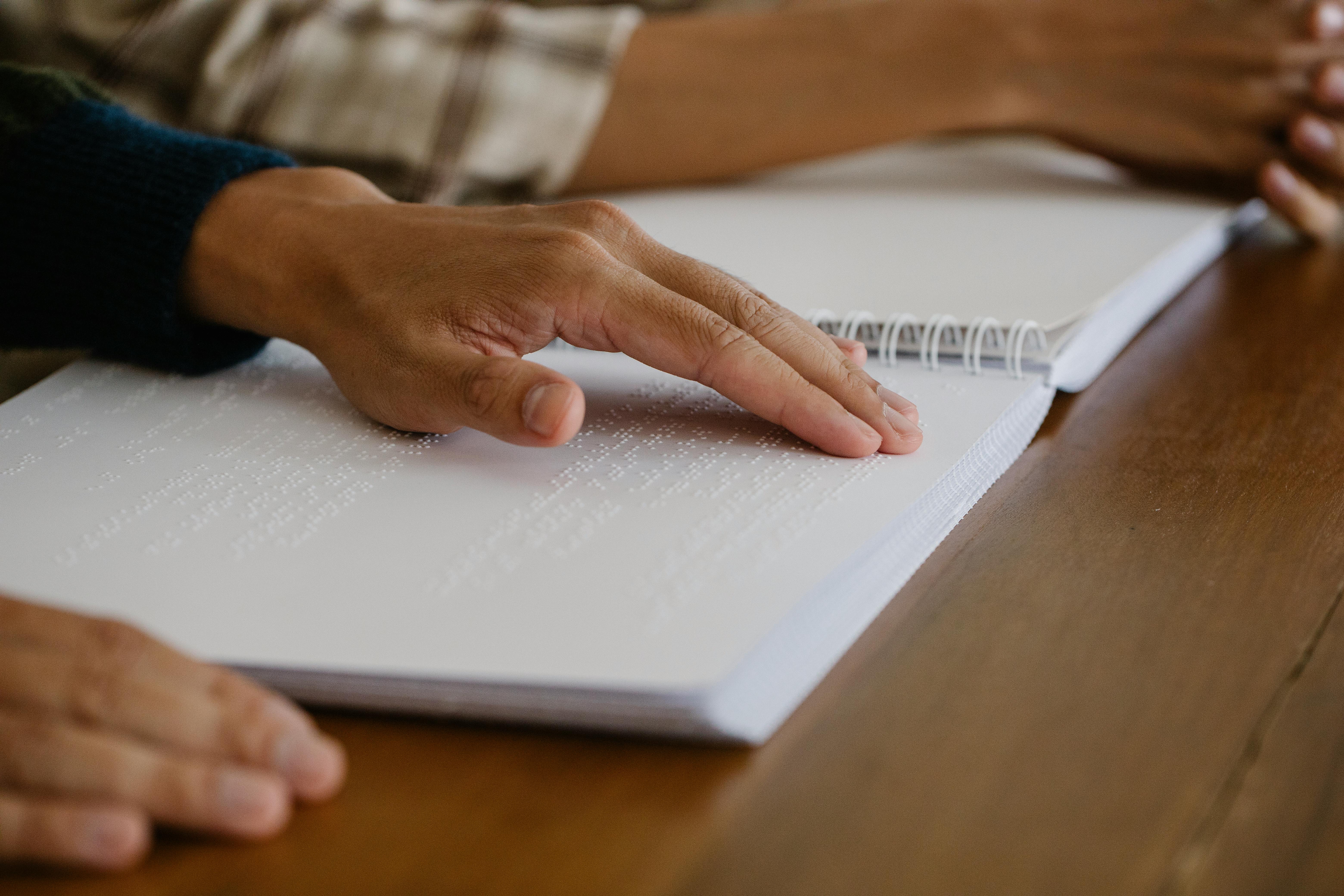 photo of person learning braille