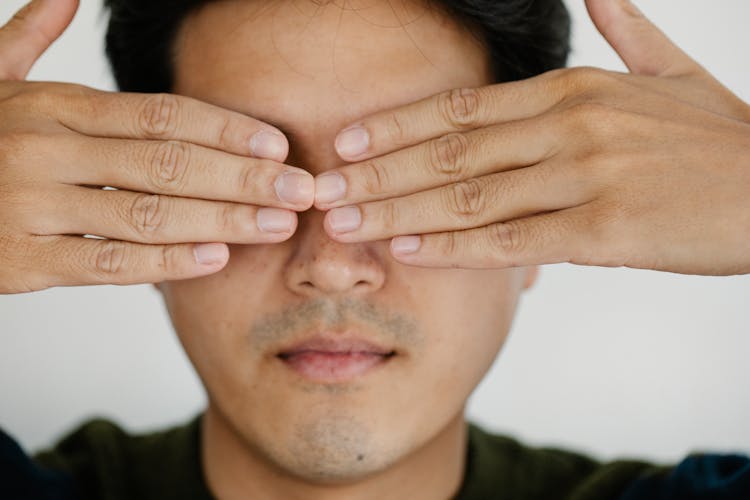 Photo Of Man Covering His Face