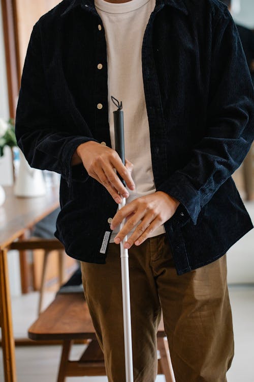 Photo of Person Holding Walking Stick 