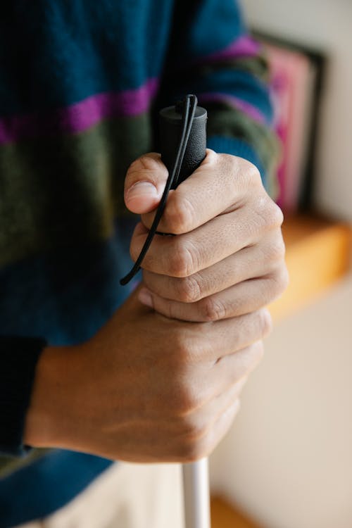 Photo Of Person Holding Walking Stick 