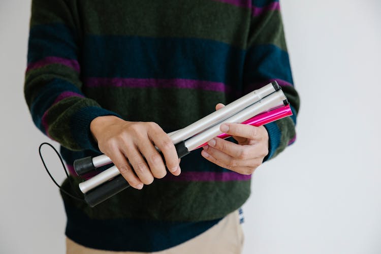 Photo Of Person Holding Dismantled Walking Stick