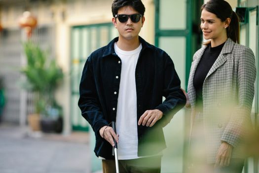Photo of Woman Happily Assisting Blind Man 