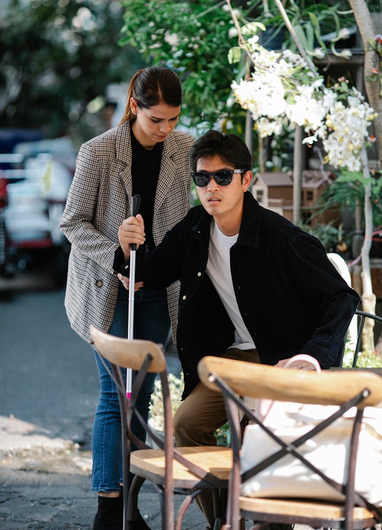 Photo Of Woman Helping Man Get Up On The Chair