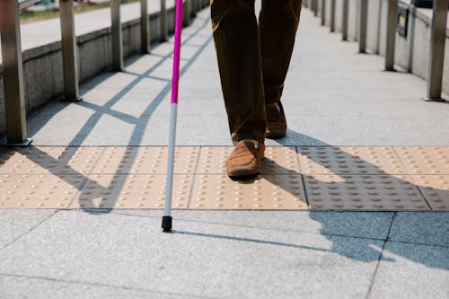 Photo of Person Using Cane for Walking 