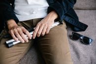 Photo of Person Holding Dismantled Walking Stick