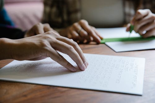 Free Shallow Focus Photo of Person Using Braille Stock Photo