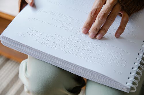 Photo of Person Holding White Braille Paper