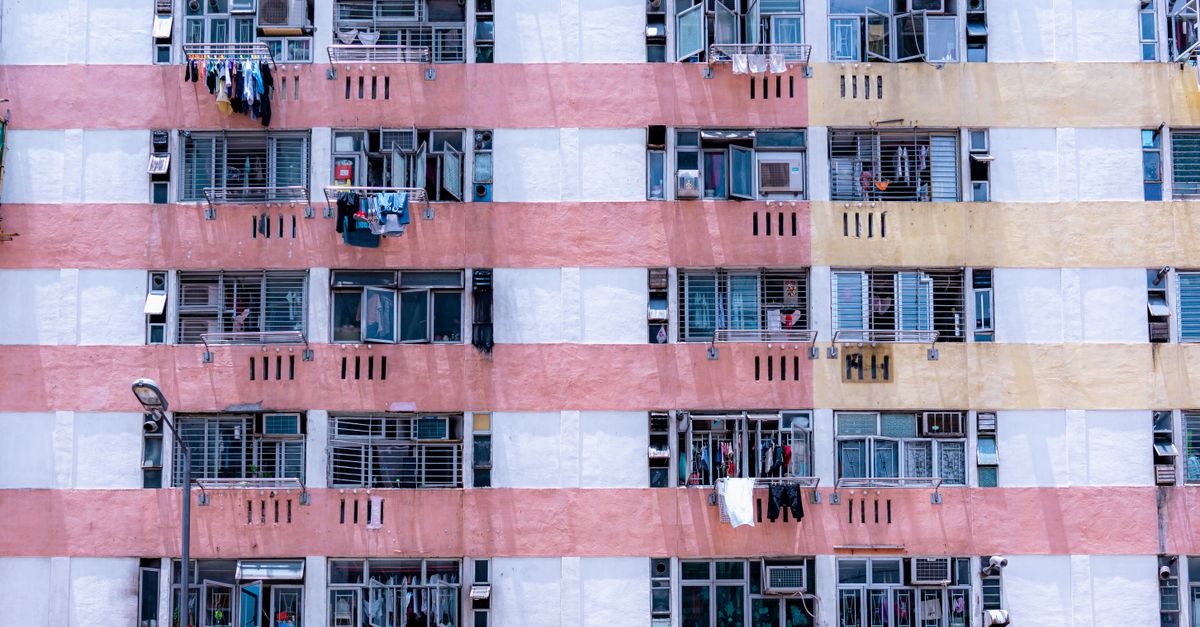 Close-up of a colorful apartment building facade showcasing urban architecture with laundry hanging outside.