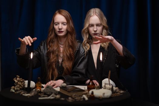 Women Putting Hands Over Burning Candles