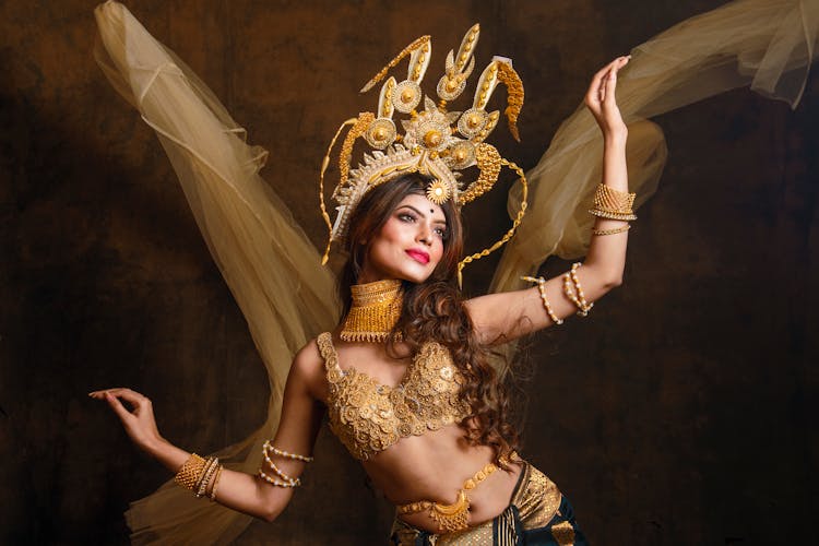 Woman In Gold Bra And Headdress