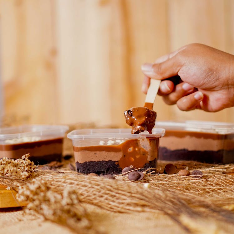 A Person Scooping An Ice Cream 