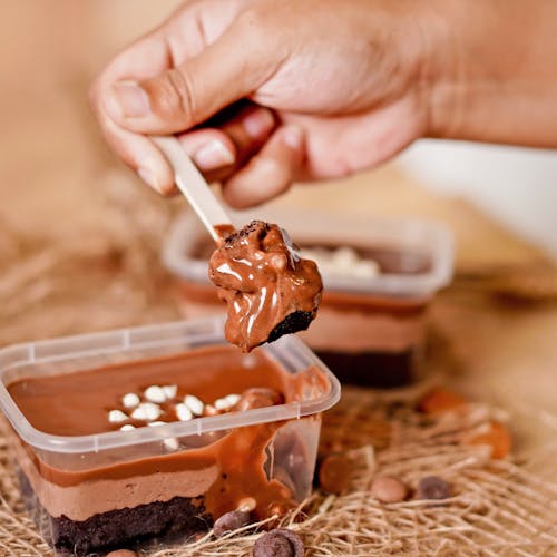 Free Person Holding Spoon With Chocolate Cake Stock Photo