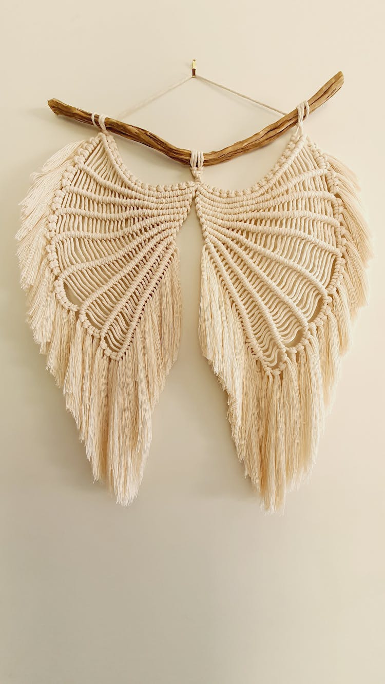 Macramé Wings On Wooden Stick On The Wall
