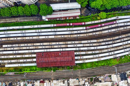 Free Aerial view of a busy train depot with multiple tracks in Jakarta, Indonesia. Stock Photo