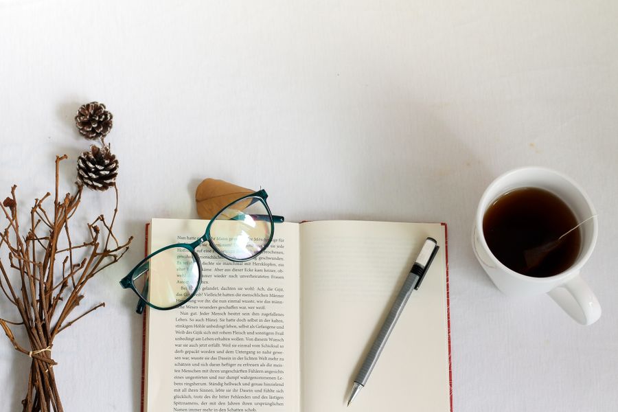 Open diary and writing accessories on a warm desk