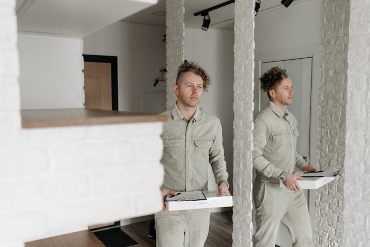 A Man Delivering A White Box