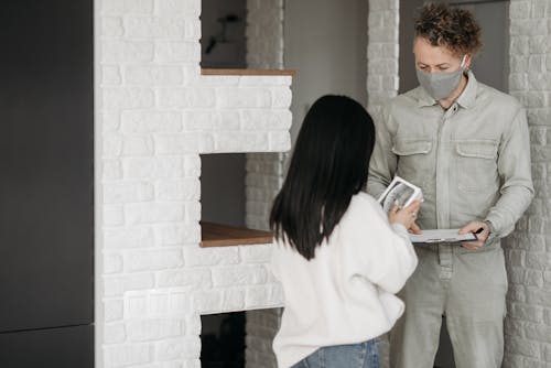 A Man Delivering a Package to a Woman