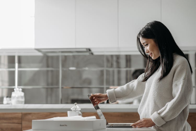 Woman Opening A Macbook Pro Laptop