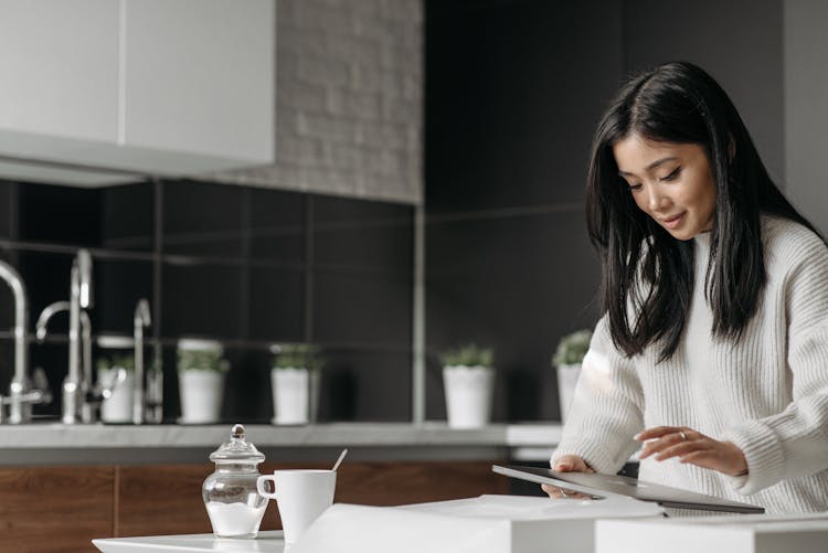 Photograph Of A Woman Holding Her Laptop