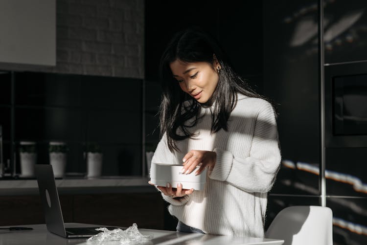 Woman Unpacking An Iphone 