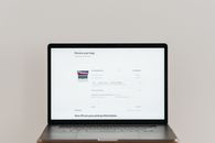Minimalist laptop showing an online checkout screen on a white background, ideal for tech context.