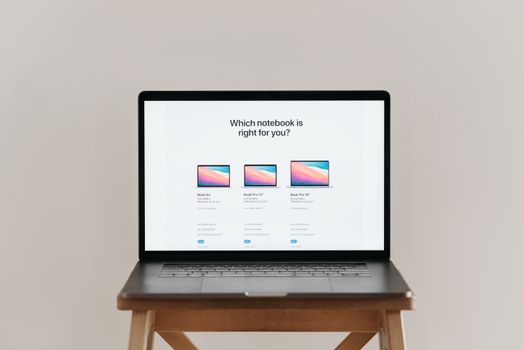 An open laptop on a wooden stool showing a notebook comparison chart, ideal for tech-focused imagery.
