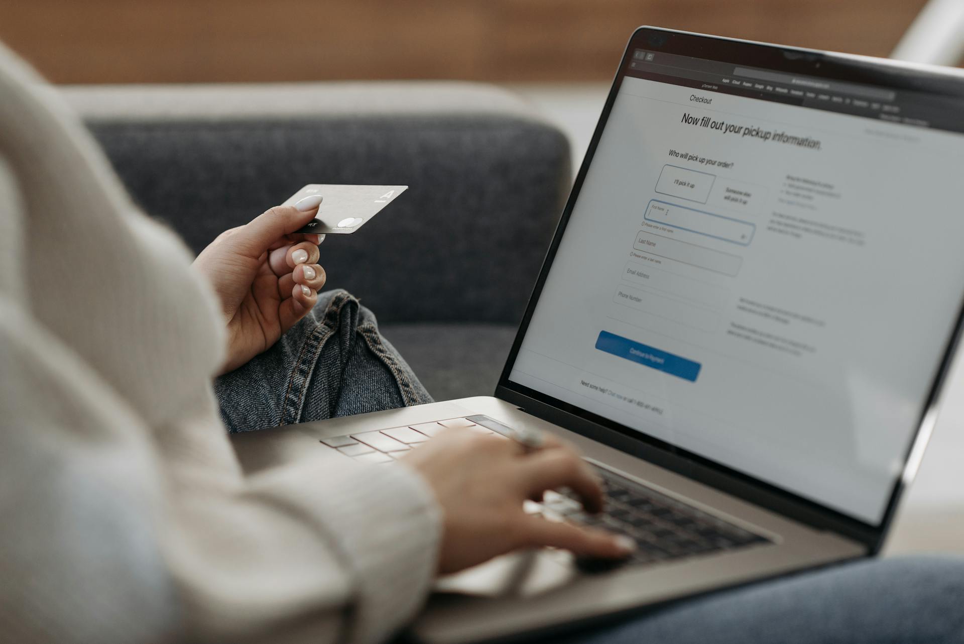 Woman Holding a Credit Card and a Laptop Computer