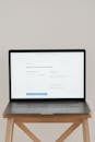 Laptop on Brown Wooden Table