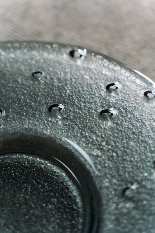 Free Elevated view of a textured glass plate with droplets, showcasing elegant design. Stock Photo