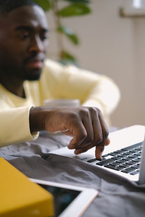 Man Computer Yellow Man in Yellow Sweater using Laptop · Free Stock Photo