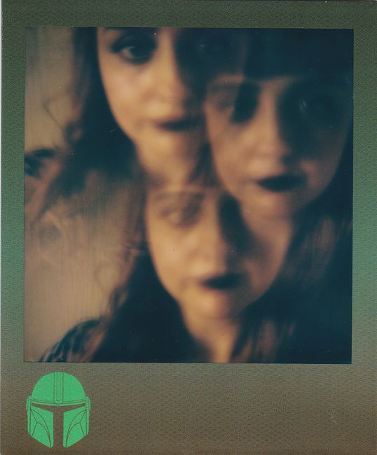 Vintage Polaroid portrait with blur and double exposure effect featuring a woman's face.