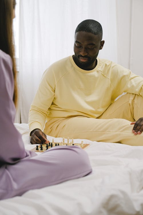 Free Man and Woman Playing Chess Stock Photo