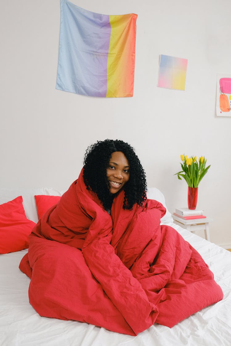 Cheerful Black Woman Wrapped In Blanket