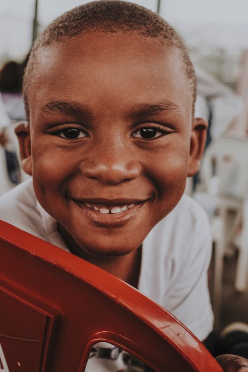 Free Close-up of a happy child smiling outdoors. Stock Photo