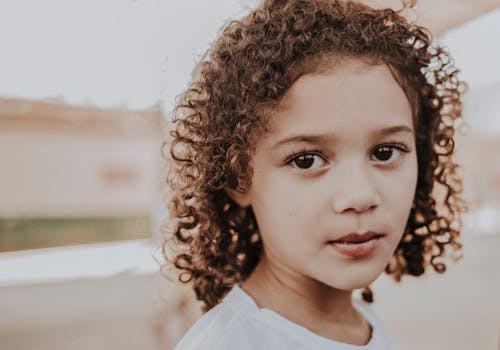 A Young Girl with a Curly Hair