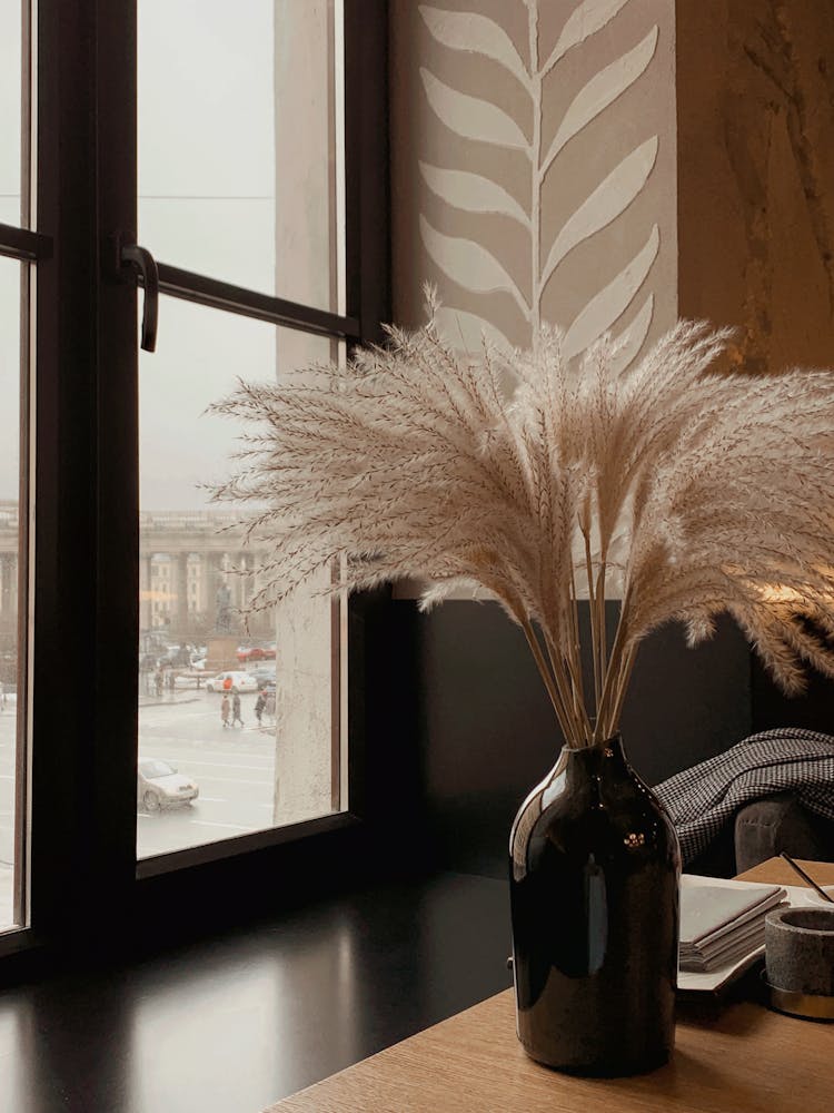 Vase Of Dried Pampas Grass On Table Near Window