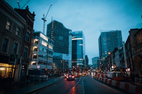 Transport traffic on urban road between multistory buildings at night