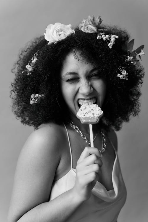 Monochrome Photography of Woman eating Lollipop