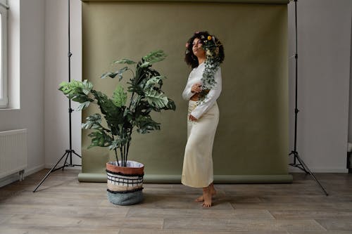 Woman Standing Beside Big Potted Plant