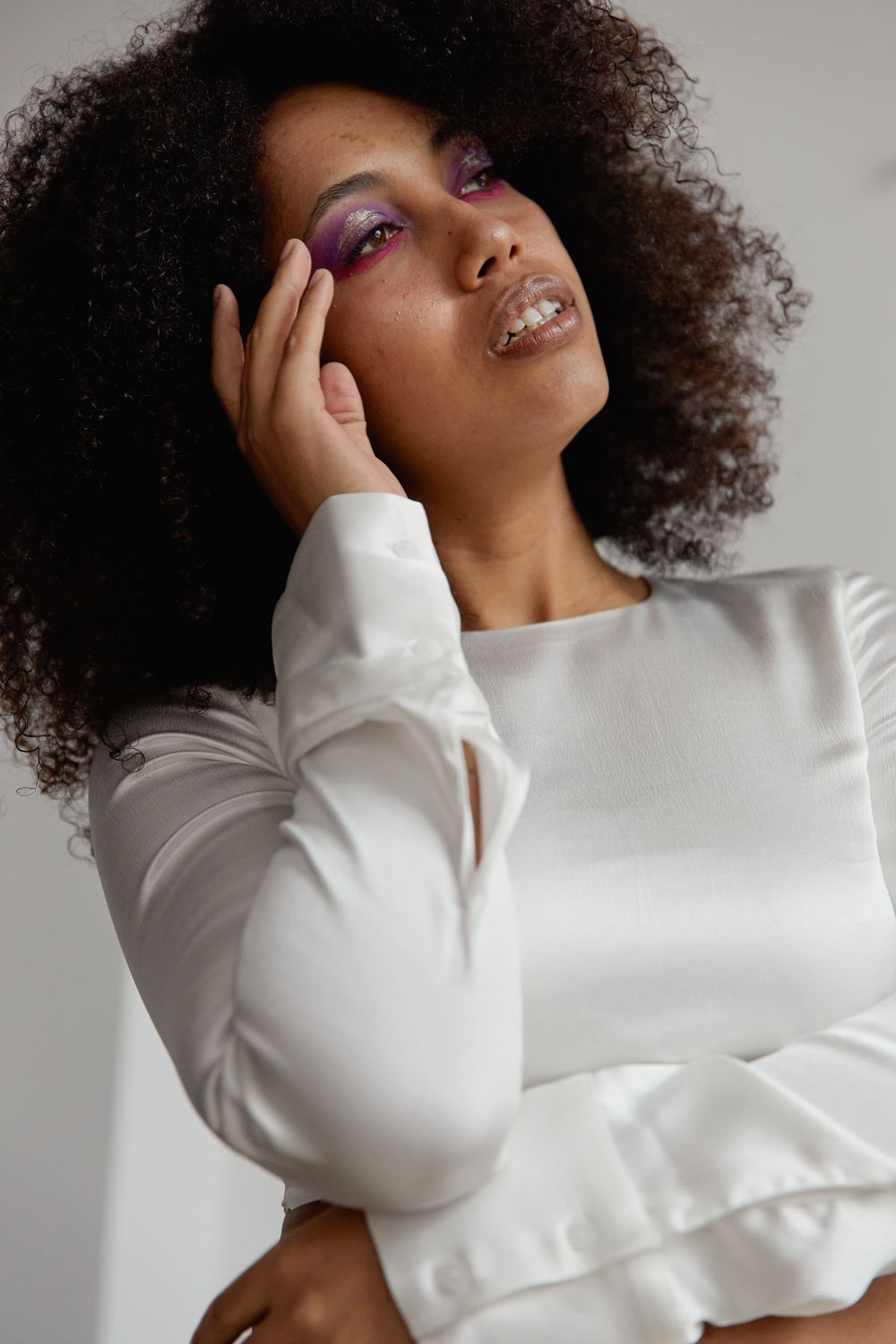 Low-Angle Shot of a Woman with Afro Hair Posing with Her Hand on Her ...