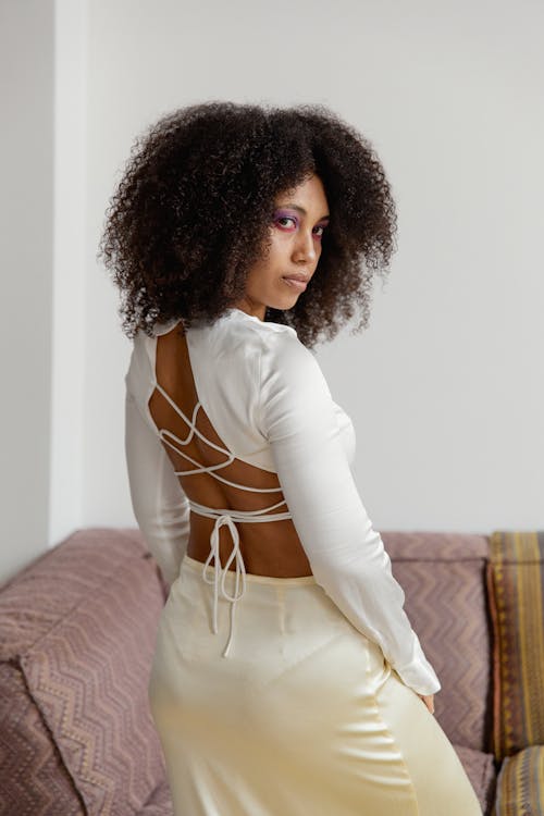Photo of a Woman with Afro Hair Looking Back