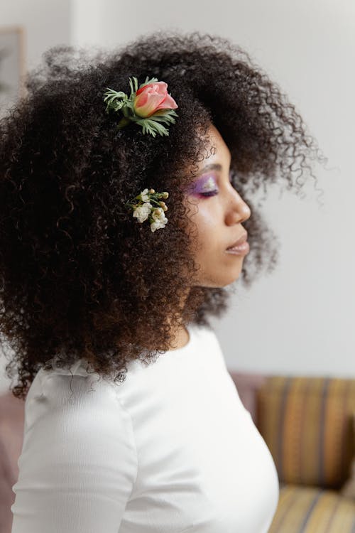 Woman in White Shirt With Flower on the Head