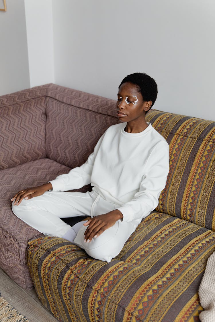 Woman Sitting On A Couch Meditating