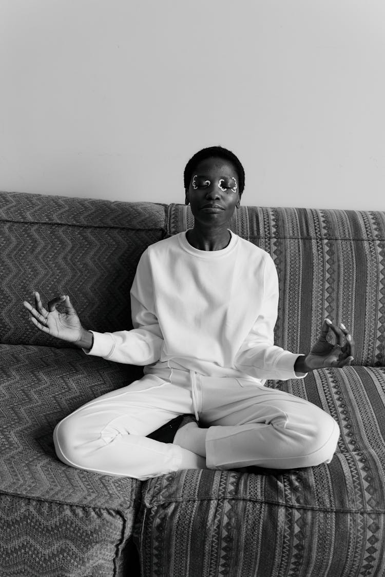 Woman In White Long Sleeve Shirt And Pants Sitting On Couch